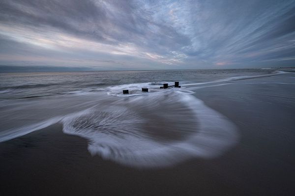 Jaynes Gallery 아티스트의 USA-New Jersey-Cape May National Seashore Pier stumps on cloudy seashore sunrise작품입니다.